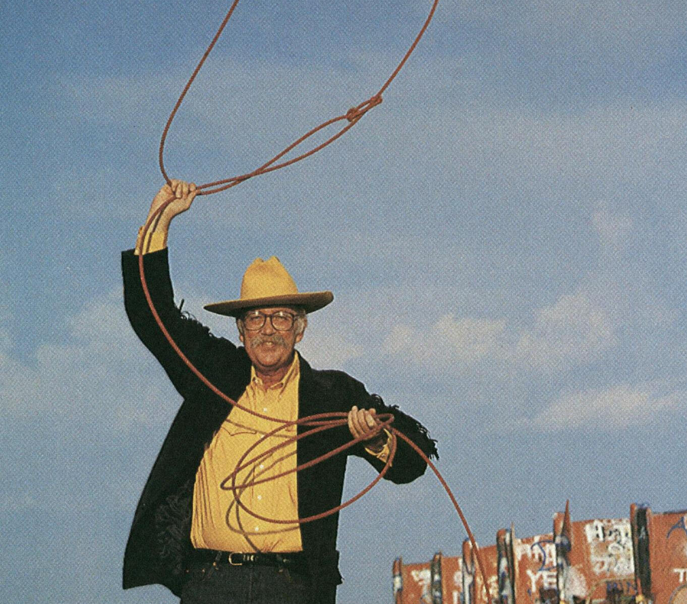 Confident middle-aged man standing by window in morning light, representing vitality and balanced energy for men over 40