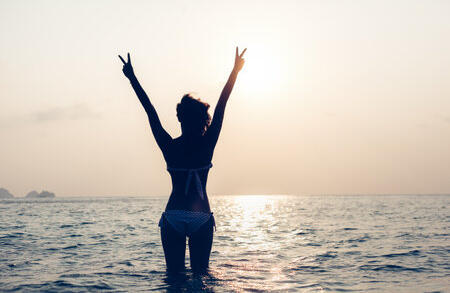 woman over 40 enjoying peaceful sunset moment with a calm and confident expression